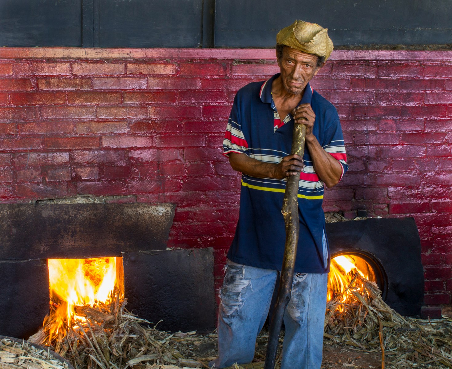 man with workers' compensation insurance wearing blue polo shirt near firepit